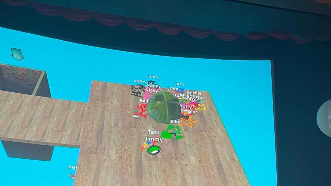 Audience working together to roll a virtual cabbage into a virtual blender
